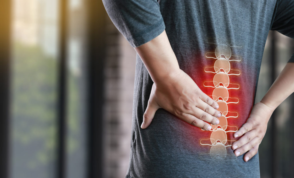 man suffering back pain chiropractic treatment